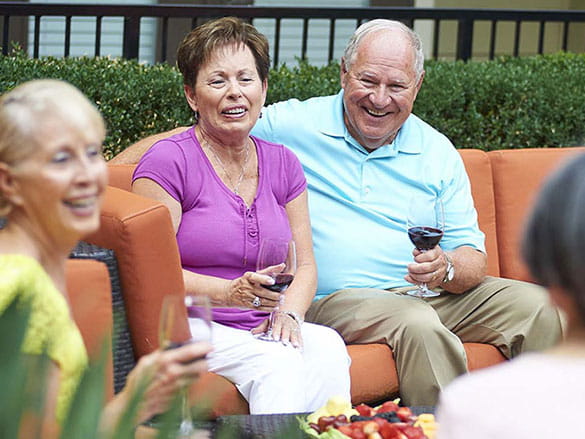 Adults sitting outside enjoying a beverage