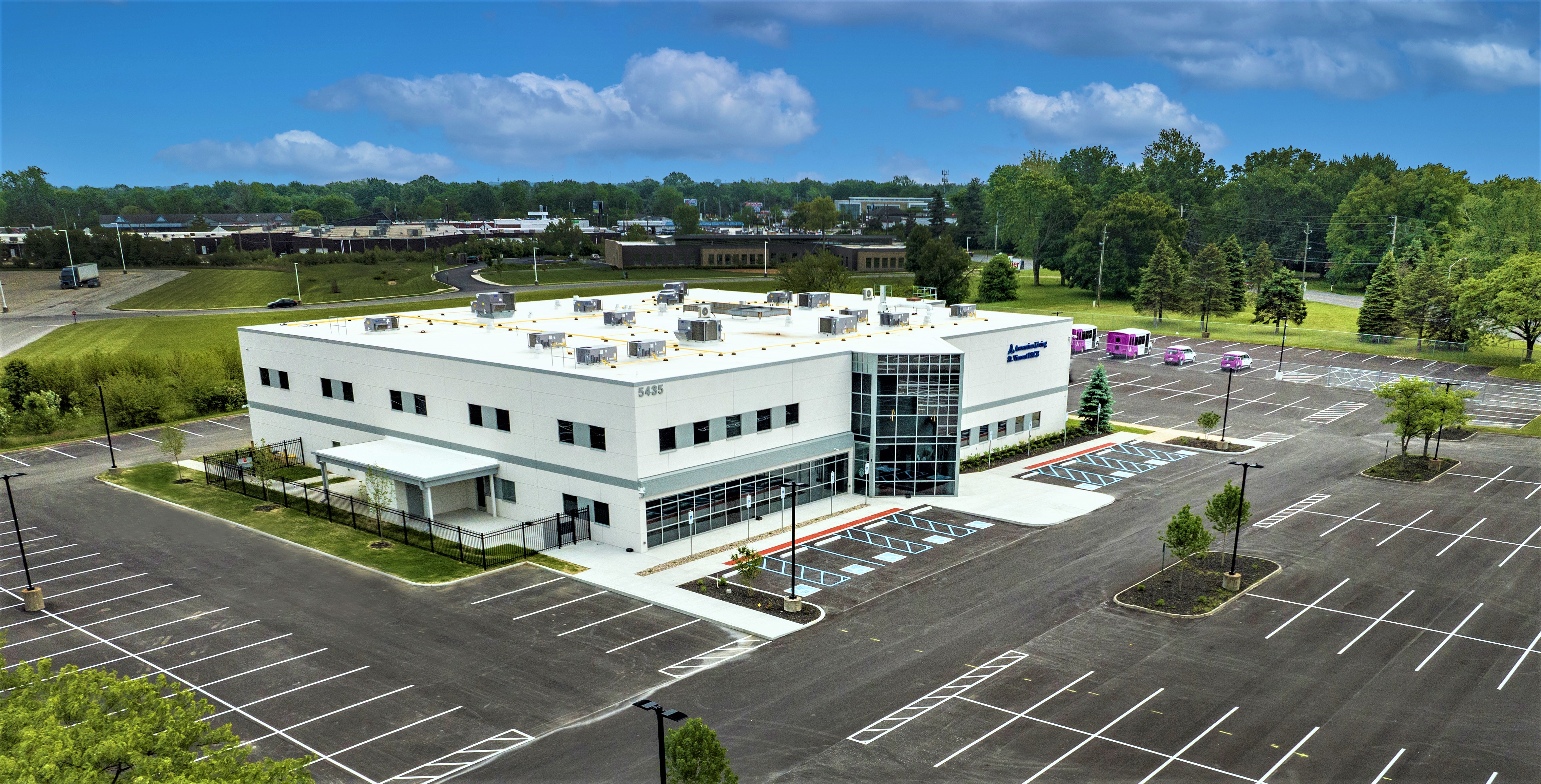 Aerial view of Ascension Living St. Vincent PACE center building under a clear sky in Indianapolis.